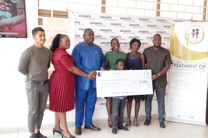 Dr Karl Laryea, Chief Executive Officer of Knights a.s. Ghana Limited (third from left) and Ms Akua Sarpong, Executive Secretary of LCCG at the Department of Child Health of the Korle Bu Teaching Hospital, (third from right) pose with the dummy cheque 