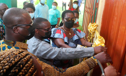 Mrs Ursula Owusu-Ekuful (right), the Minister of Communications and Digitalisation, being assisted by other officials to inaugurate the laboratory