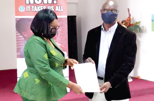 Rev. Celia Apeagyei-Collins (left) of Rehoboth Foundation exchanging copies of the MoU with Mr Dickens Thunde, CEO of World Vision Ghana