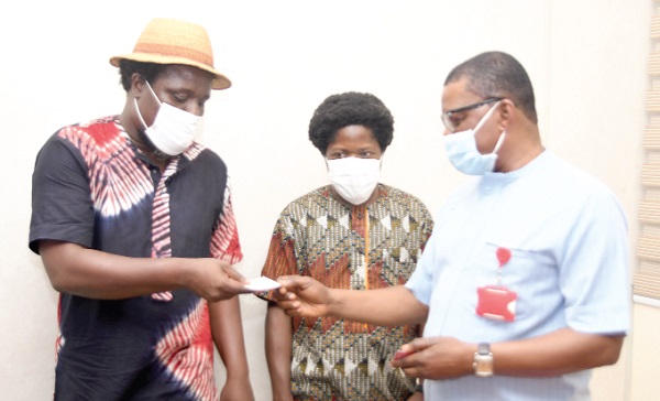 Mr Kobby Asmah (right), Editor of the Daily Graphic, exchanging contacts with Mantse Aryeequaye, Director of the festival after the interview. With them is Nii Aryetey Aryeh, the Head of Operations of the festival