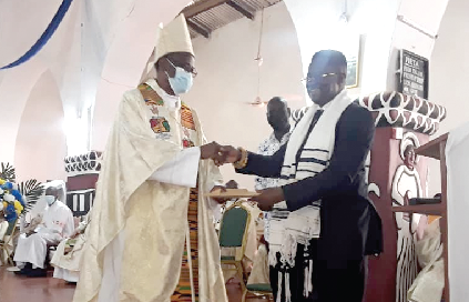Mr. John-Peter Amewu (right), the Minister of Railway Development, presenting GH¢20,000, on behalf of the Vice-President, Dr. Mahamudu Bawumia, to Most Rev. Alfred Agyenta, the Bishop of the Navrongo-Bolgatanga Diocese