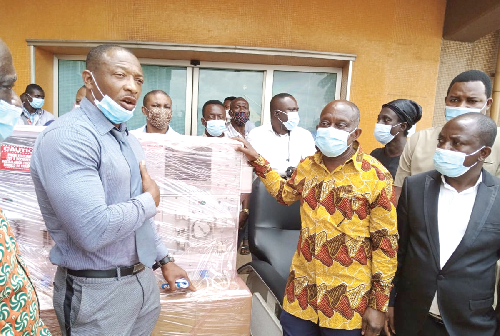 Dr Al Majid Adams (left), the secretary to the foundation, presenting the items to Mr Simon Osei-Mensah, the Ashanti regional minister