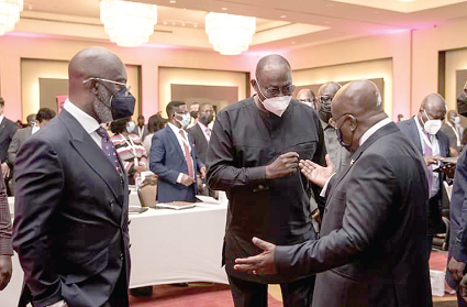 Mr. Spio-Garbrah explaining a point to President Nana Addo Dankwa Akufo-Addo. Standing left is Yoofi Grant, CEO of Ghana Investment Promotion Centre