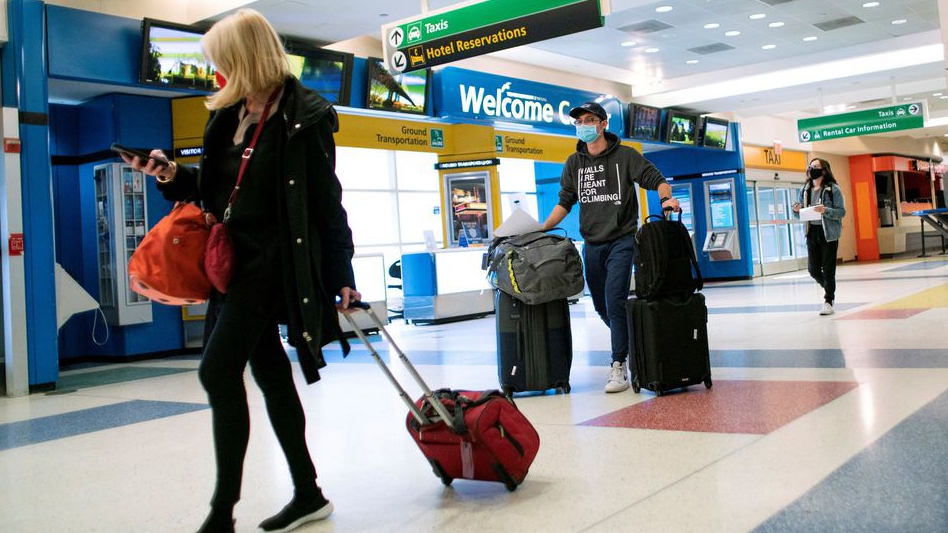 Passengers arrive on a flight from London amid new restrictions to prevent the spread of coronavirus disease at JFK International Airport in New York City, U.S., December 21, 2020.