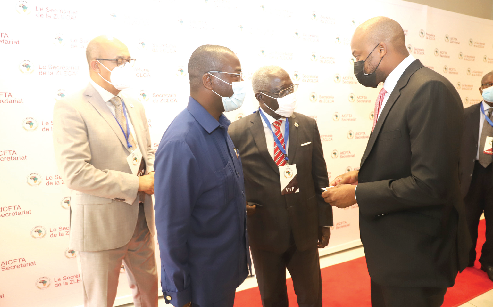Mr Wamkele Mene (right), Secretary General of the AfCFTA Secretariat, interacting with Mr Yaw Osafo-Maafo (2nd right),  the Senior Presidential Advisor, during the meeting of Heads of Regional Economic Communities in Accra. Those with them are Ambassador Joao Baptista Domingos Quiosa  (2nd left) and Mr Abdaerrahim Kadmiri (left), Executive Secretary of the Community of Sahel Saharan States. Picture: GABRIEL AHIABOR