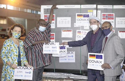 Mr Daniel Krull (2nd right) symbolically hands over the consignment of vaccines to Mr Mahama Seini (in smock) while officials of the EU look on