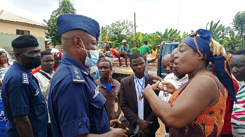 Mrs Queenstar Pokuah Sawyerr (right), MP for Agona East, explaining a point to Deputy Superintendent of Police George Adanye (2nd left) of the Swedru Divisional Police Command when he led personnel to the scene