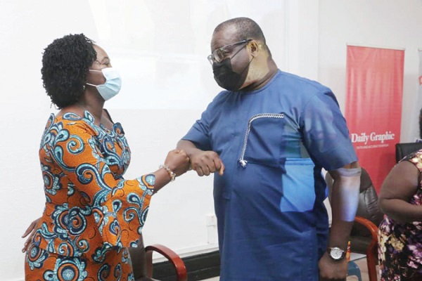 Mr Theophilus Yartey (right), Deputy Editor, Daily Graphic, exchanging pleasantries with Mrs Justina Marigold Assan, the Central Regional Minister, at the sanitation awareness forum in Cape Coast