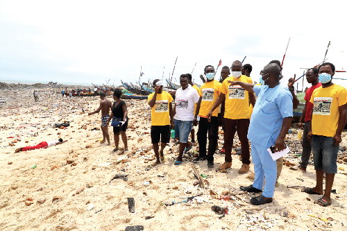 Mr Raymond Ntoana Tettey (hand raised), Chairman of the Ashiedu Keteke Sub-Metro, explaining a point to the community champions about the situation at the beach after the ceremony. Picture: GABRIEL AHIABOR
