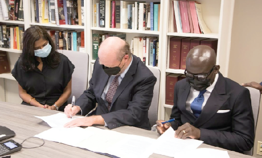 Mr. Godfred Yeboah Dame (right), the Attorney-General, and Professor William Treanor (middle), Dean of the Georgetown University Law Center signing the agreement in Washington DC, US
