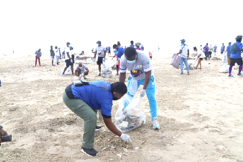 Mr Solomon Kotey-Nikoe (2nd left), the Municipal Chief Executive for La-Dadekotopon, and other officials cleaning the Laboma beach. Picture: GABRIEL AHIABOR