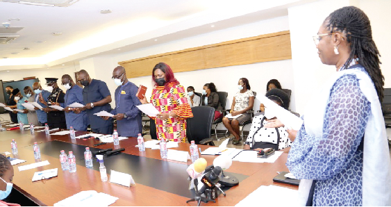 Mrs. Ursula Owusu-Ekuful (right), Minister of Communications and Digitalisation, swearing the board of the Ghana Domain Name Registry into office