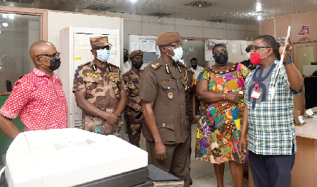 Mr. Kobby Asmah (right), Editor of the Daily Graphic taking Mr. Isaac Kofi Egyir (middle), acting Director-General of the Ghana Prisons Service through the production of the paper. With them are Mr. Samuel Akolbire (2nd left), Director, Operations of Ghana Prisons Service, Ms. Mary Mensah, Foreign Editor and Mr. Kwame Asare Boadu, a Deputy News Editor, both of the Daily Graphic