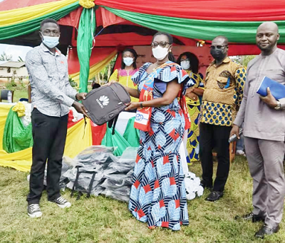 Mrs Ursula Owusu-Ekuful (right), the Minister of Communications and Digitalisation, presenting one of the bags to a representative of the two communities