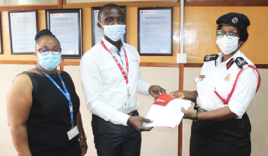 DCFO Anna A.O. Obeng (right) receiving the Tom Cards for the fuel from Mr. Frank Boamah while Ms. Lucky Worchie of the TPGL looks on