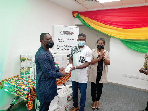 Mr Hebert Krapa (left), Deputy Minister of Trade and Industry, presenting inputs to a beneficiary of the YiEP. Looking on is Ms Afua Asabea Asare, CEO of GEPA