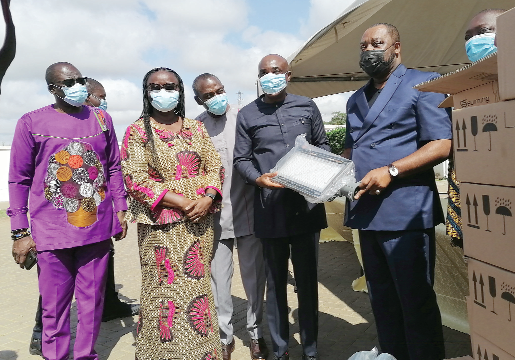  Dr. Matthew Opoku Prempeh (right), the Education Minister, handing over one of the bulbs to Prof. Abednego Amartey (left), the Chairman of Vice-Chancellors Ghana, while other vice-chancellors and some representatives look on