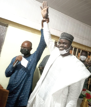 Mr Robert Yaja Dawuni ( right) being declared the MCE for Gushegu by Mr Lucas Yiryil (left), Northern Regional Director of the EC, after his confirmation by the assembly