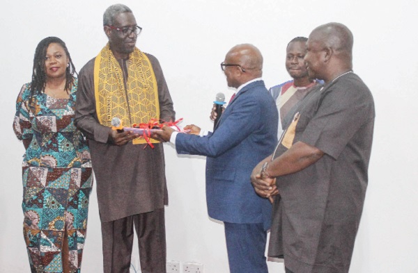  Nana Kwesi Agyekum-Dwamena (2nd from left), Head of Civil Service, handing over documents of the devolution of staff to Dr Nana Ato Arthur (2nd from right), Head of the Local Government Service. Picture: ERNEST KODZI