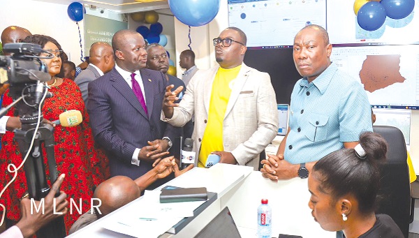 Dr Sylvester Akpah (middle) explaining the operation of the various sections of the tracking centre to Samuel Abu Jinapor (left), Minister of Lands and Natural Resources. With them is Martin Ayisi, CEO of the Minerals Commission