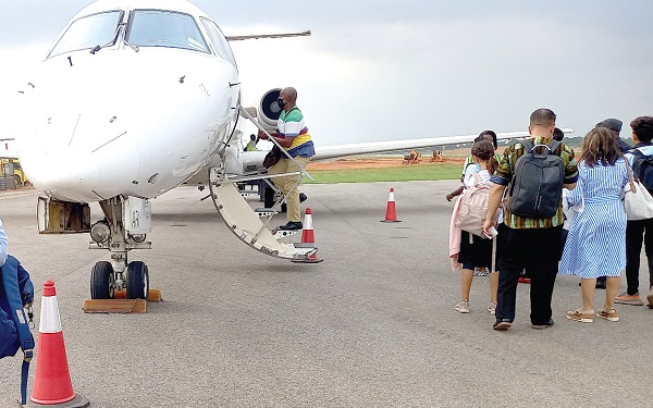  Some passengers boarding a domestic flight in Accra