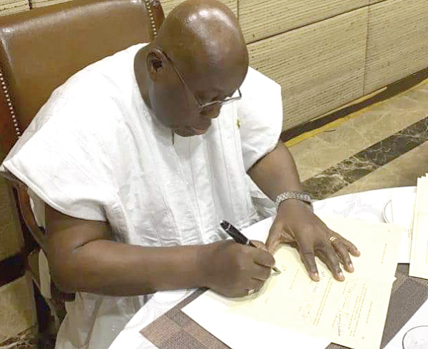  President Akufo-Addo appending his signature to the bill