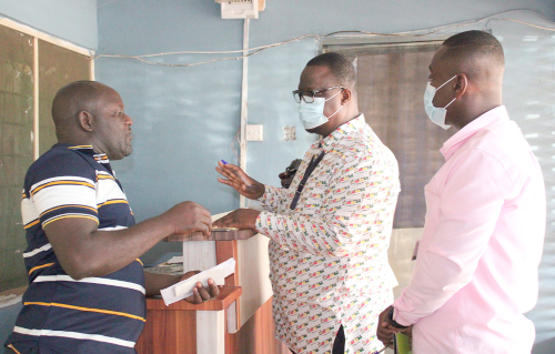 Frederick Adjei-Rudolph (middle), GTA Eastern Regional Director, interacting with Asamoah Addo (left), Manager of Dadi's Motel and Pub, as Rexford Ameyaw (right), Accountant of GTA, Eastern Regional Office, looks on