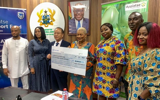 Rev Dr Joyce Rosalind Aryee (middle) receiving the dummy cheque for the amount from  Mr Zang Hongxun (3rd left)