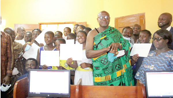  The beneficiaries displaying their certificates. With them are Nana Effah Openamang III (in traditional cloth), Chief of Obomeng,  Prince Ofosu Sefah (in suit), Chief Executive Officer of GIFEC, and other officials.