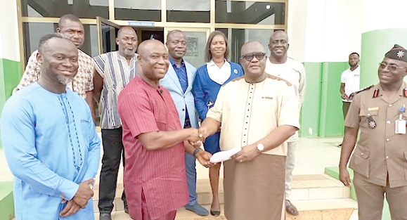 Dr Isaac Dasamni (2nd from left ) receiving the donation from  Capt. Ebenezer Afadzi. 