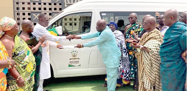 Yaw Amponsah Marfo (right), owner of Yesu Dea Transport, handing over the keys to a 14-seater new Toyota Hiace mini-bus to Daasebre Osei Bonsu, the Mamponghene and Vice-President, Ashanti Regional House of Chiefs, while other members of the ARHC look on. Picture: EMMANUEL BAAH