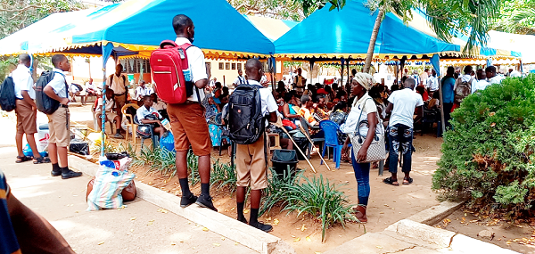   Some fresh students of St Thomas Aquinas Senior High and their parents/guardians going through  administrative procedures on the school premises yesterday. Picture: ESTHER ADJORKOR ADJEI