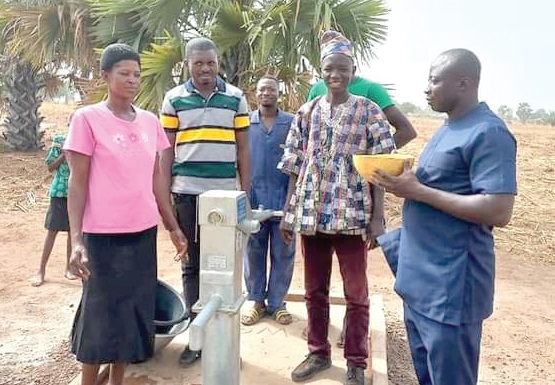  Joseph Louknaan (right), DCE for Bunkpurugu-Nakpanduri tasting the water from the borehole