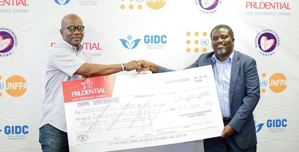 Emmanuel Mokobi Aryee ( left)  presenting a dummy cheque to Dr Joseph Oliver Commey, acting Director of the Ghana Infectious Disease Centre