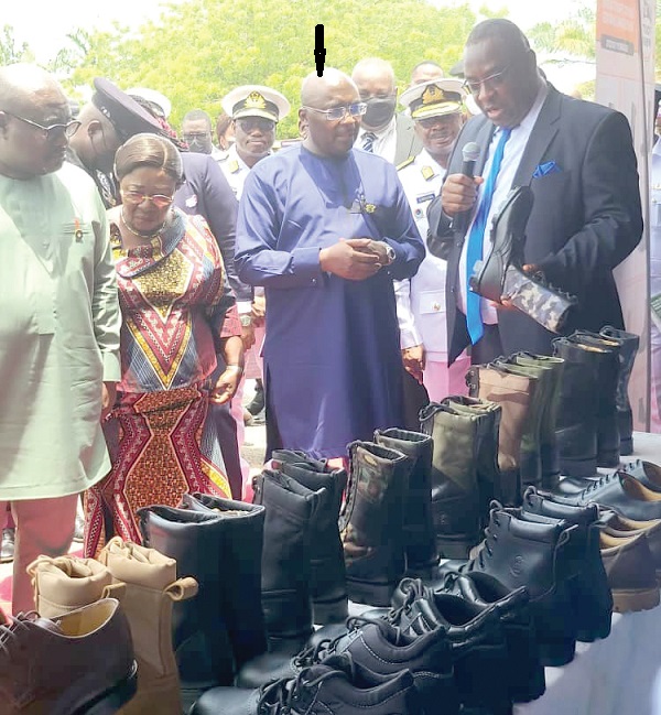 Dr Karl Laryea (right), Board Chairman of DIHOC Footwear Division Limited,  showing some of the shoes to Vice-President Dr Mahamudu Bawumia (arrowed); Akosua Frema Osei-Opare (2nd from left), Chief of Staff, and other dignitaries