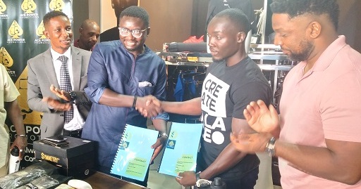 Mr Isaac Amankwah, Managing Director of ACE Power Promotions, exchanging the signed documents with Mr Emmanuel Jojo-Forson, General Manager of Symmetry Gears