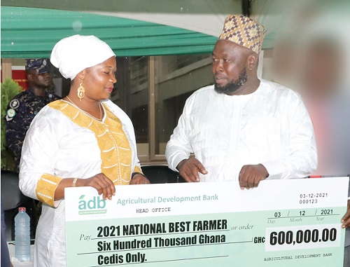 Alhaji Mohammed Mashud (right), the 2021 National Best Farmer, with Suhuyini Ubaida, his wife, after receiving the cheque