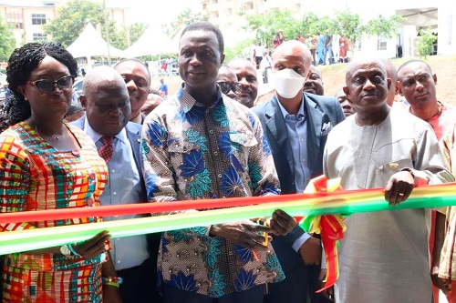 Dr Yaw Osei Adutwum (middle) cutting a tape to inaugurate an engineering workshop at Adako Jachie in the Ashanti Region. With him are Simon Osei Mensah (right), and Gifty Twum Ampofo (left), Minister of Education in-charge of TVET.