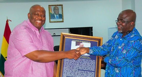   Jeremaine Nkrumah (right), Board Chairman of National Road Safety Authority, presenting a citation to Henry Quartey (left), Greater Accra Regional Minister. Picture: ELVIS NII NOI DOWUONA