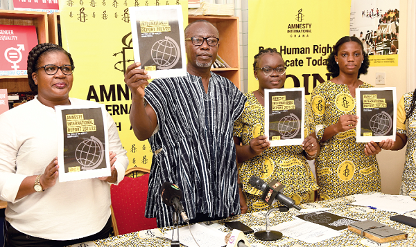 George A.B. Aggrey (2nd from left) Board Chairman of Amnesty International Ghana (AI), launching the 2021-2022 Amnesty International state of the world’s human rights report. With him are Cynthia Adu Darko (left) Board member, Hannah Osei (2nd from right), Human Rights Education and Youth Engagement Co-ordinator, and Belinda A. Asamanyuah, Campaign and Communication Co-ordinator, all of AI Ghana. Picture: EBOW HANSON ­