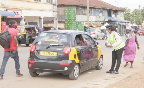 A police officer checking the insurance and licence of a taxicab during the exercise