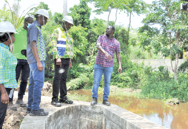 Samuel Kofi Dzamesi (2nd from right),  CEO, Bui Power Authority, inspecting a facility at the micro-hydro generating station