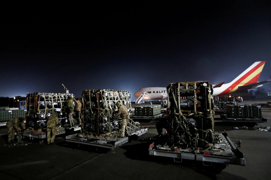 Ukrainian service members unpack antitank missiles, delivered by plane as part of the U.S. military support package, at the Boryspil International Airport outside Kyiv on Feb. 10. (Valentyn Ogirenko/Reuters)