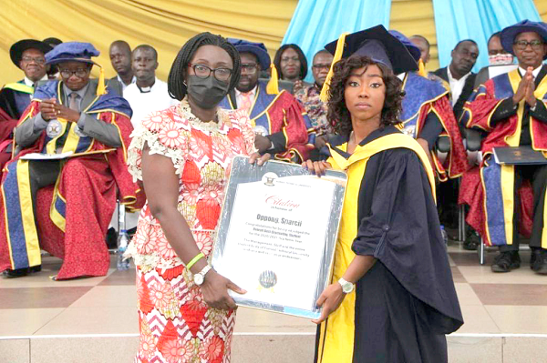  Gifty Twum Ampofo (left), Deputy Minister of Education in charge of Technical,  Vocational Education and Training (TVET), presenting a plaque to Sparcil Oppong, the Overall Best Graduating Student