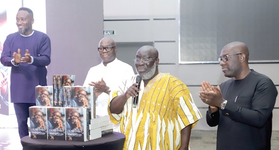 Isaac Emmil Osei-Bonsu (3rd from right), Board Chairman, National Communications Authority, unveiling the book with assistance from Kojo Oppong Nkrumah (2nd from right), Minister of Information. With them is Mr Reginald Daniel Laryea (3rd from left), Chairman of the Board of GOIL Company Limited. Picture: SAMUEL TEI ADANO