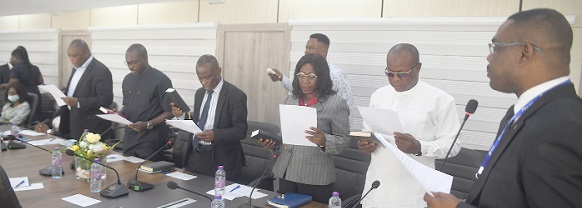  Dr Eric Oduro Osae (right), Director General, Internal Audit Agency, administering the oath to the seven-member audit committee