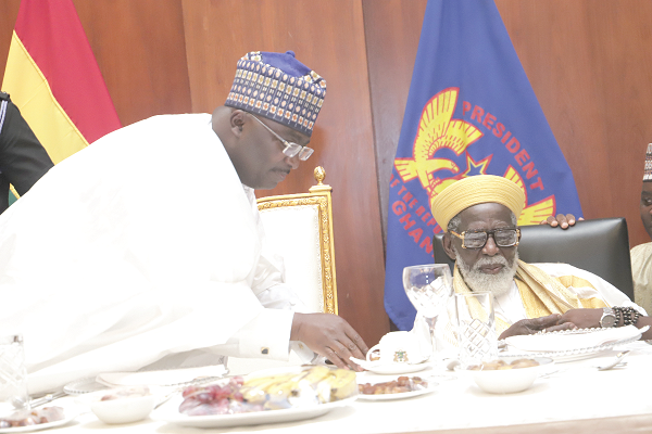   Vice-President Mahamudu Bawumia (left) assisting Sheikh Osman Nuhu Sharubutu to break the fast to mark the IFTAR at the Jubilee House. Picture: SAMUEL TEI ADANO