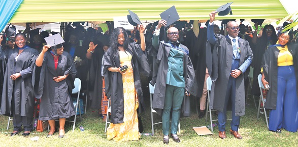 Some graduating students of the Ghana Institute of Management and Public Administration lifting their academic caps in celebration at the ceremony. Picture: ELVIS NII NOI DOWUONA