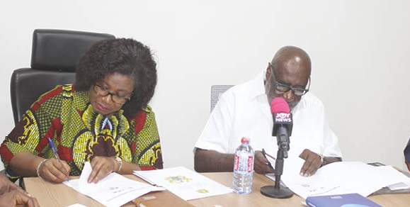 Florence Hutchful (left), a board member of the FWSC, and Joseph Winful,  Board Chairman of the IAA, signing the agreement. Picture: Ernest Kodzi  