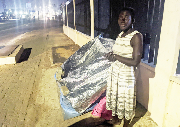 Maame Akua covering the mosquito net with plastic sheets.   Pictures:Efia Akese 